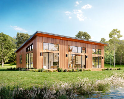 Modern single-story house with dark gray vertical siding, large floor-to-ceiling windows, and a wooden deck, situated beside a rocky stream with trees and hills in the background.