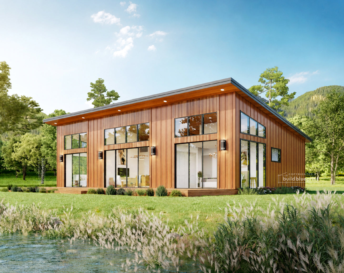 A modern single-story cabin with dark charcoal metal siding, large floor-to-ceiling windows, and a wooden roof trim, situated on a grassy bank next to a clear stream under a blue sky with trees in the background.