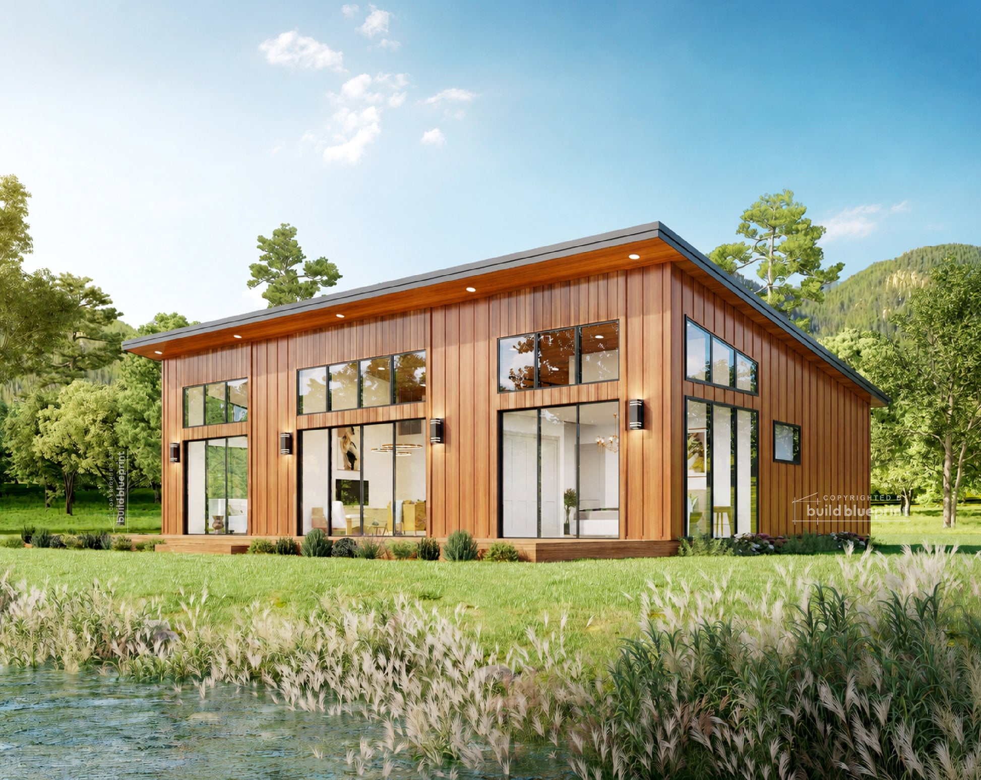 A modern single-story cabin with dark charcoal metal siding, large floor-to-ceiling windows, and a wooden roof trim, situated on a grassy bank next to a clear stream under a blue sky with trees in the background.