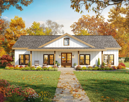 A white single-story farmhouse-style house with a gray shingled roof, stone walkway, landscaped lawn, and autumn trees in the background.