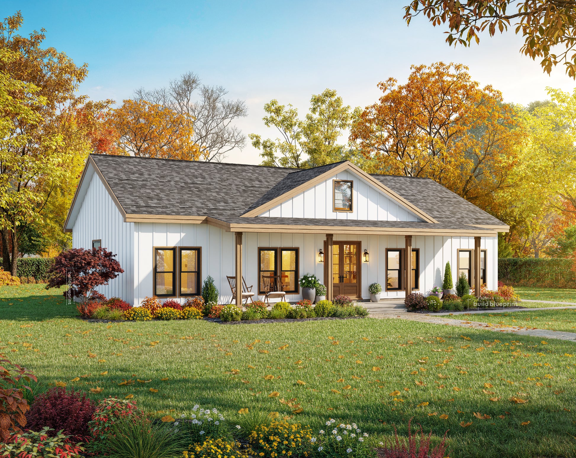 A single-story farmhouse-style home with white siding, a dark gray shingled roof, and a front porch, shown in a landscaped yard with autumn trees and a green lawn.
